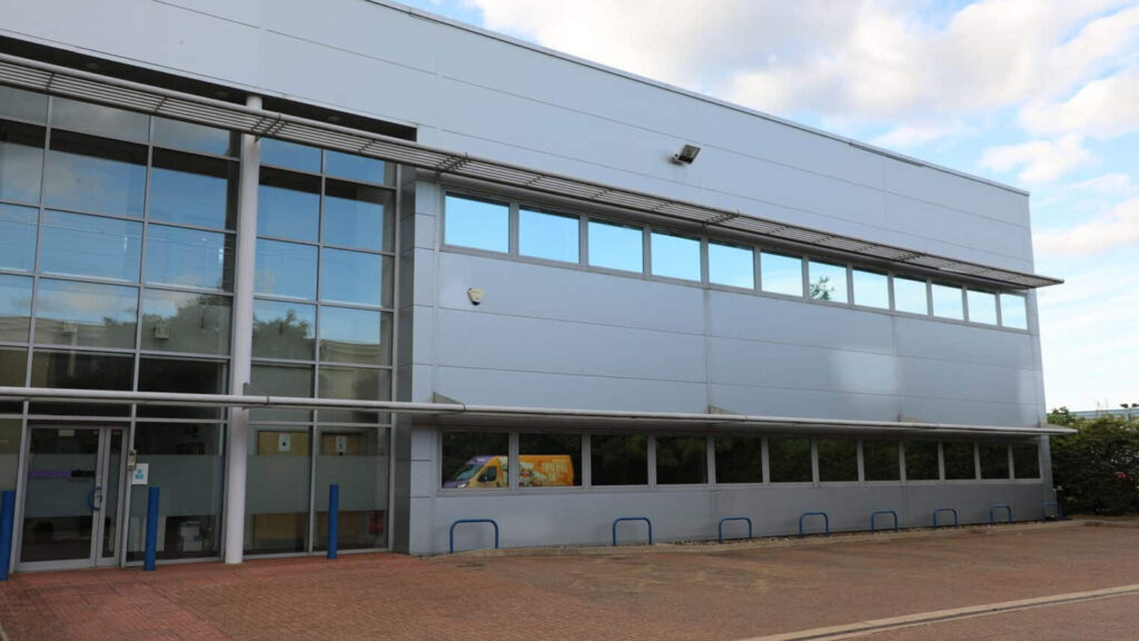 Industrial roofing maintenance in Dorset: A technician inspecting a commercial roof for potential issues.