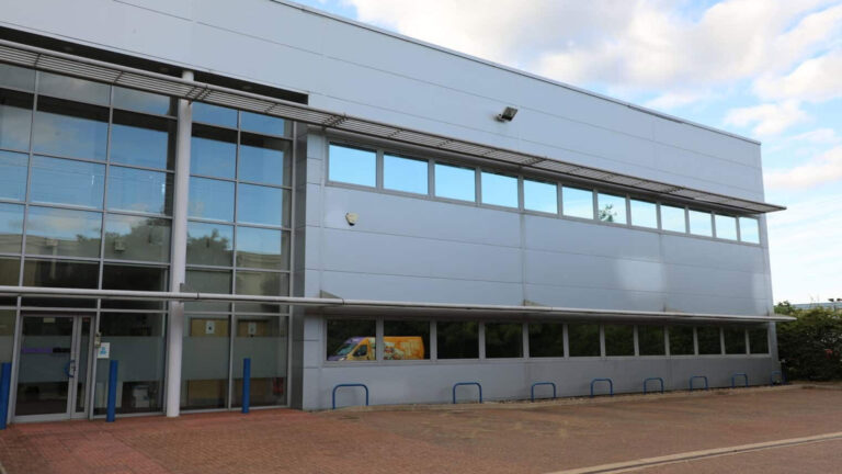 Industrial roofing maintenance in Dorset: A technician inspecting a commercial roof for potential issues.